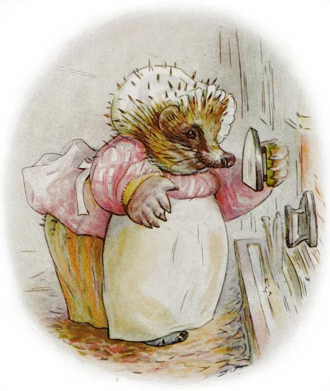Mrs. Tiggy-winkle is wearing a white mobcap with prickles poking through, a yellow skirt, a pink blouse and a white apron. She’s inspecting the bottom of an iron that she’s picked up; another stands on the side.