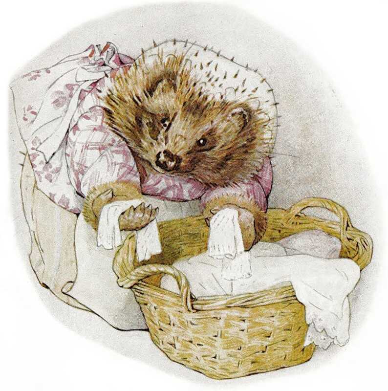 Mrs. Tiggy-winkle bends over her washing basket and pulls out two small pieces of white cloth.