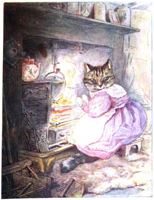 Ribby sits by the fire warming her paws. She’s wearing a pink dress with a white pinny. Next to the fire is a big teapot painted with flowers, and on the mantelpiece above are jars and knickknacks.