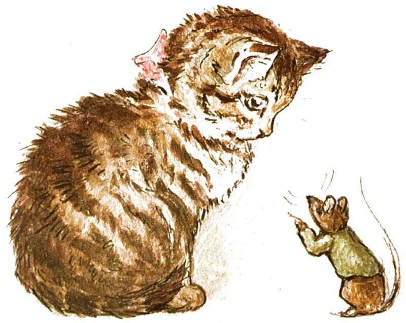 A tabby kitten wearing a pink bow is staring at a mouse in a green jacket who is sitting in front of her.