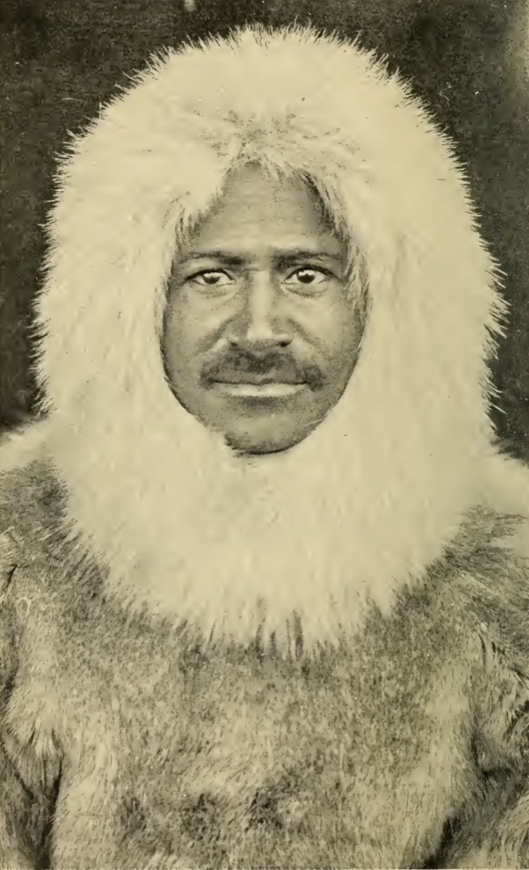 Front-facing photograph of the author in heavy fur coat and hood.