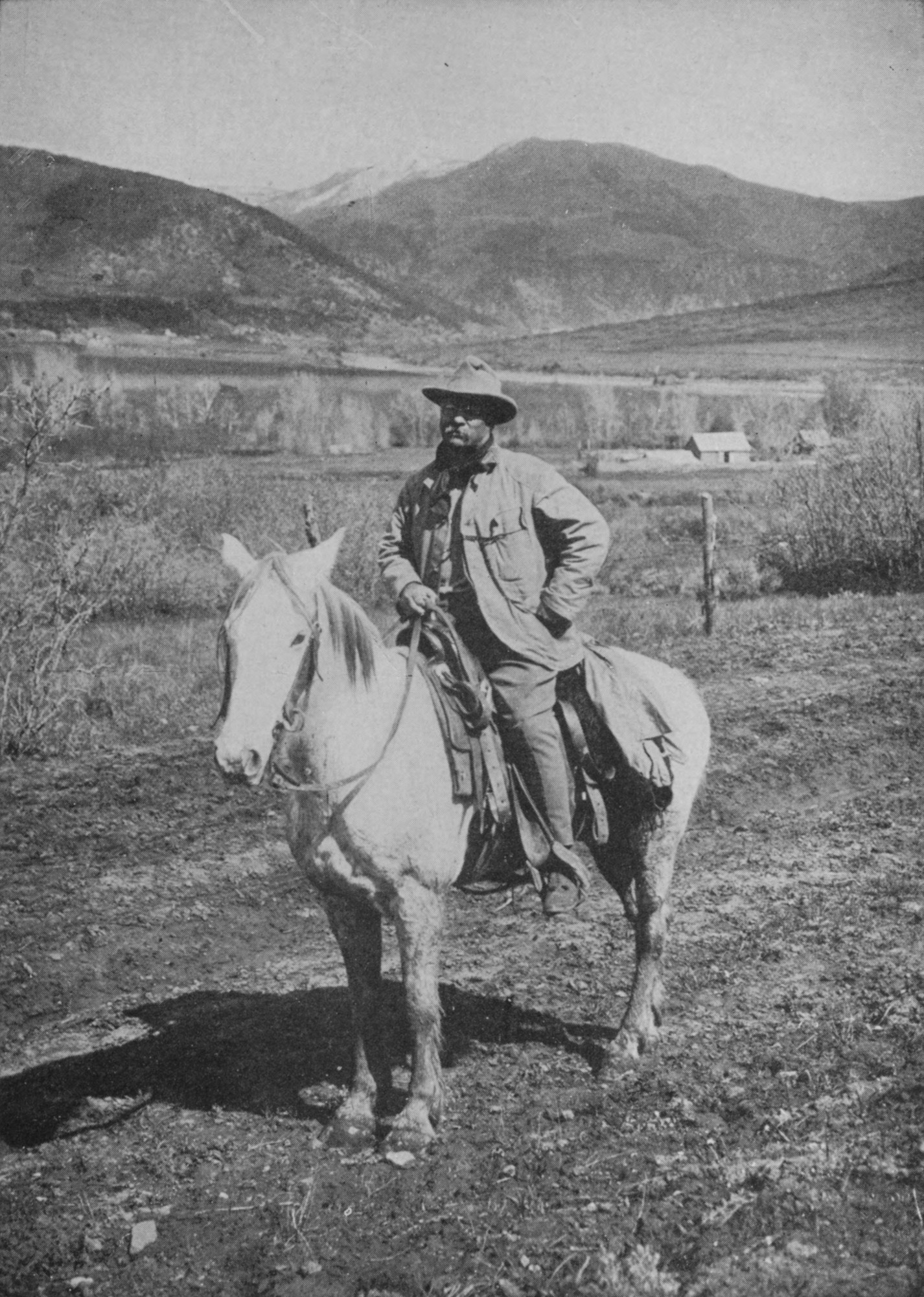 A photograph of the author seated on horseback with prairie hills visible in the background.