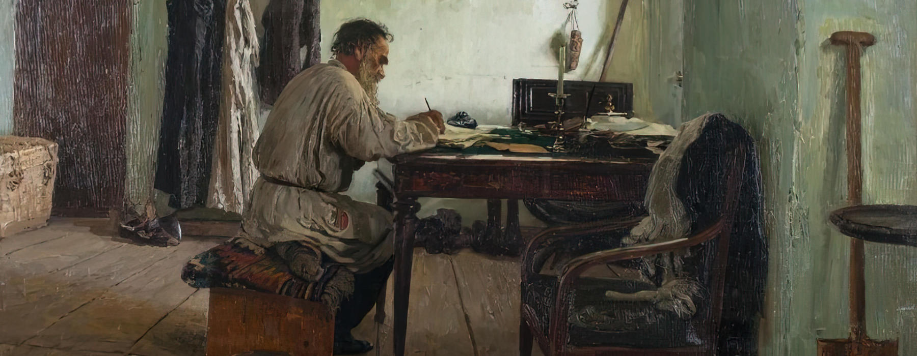 Leo Tolstoy sitting at a desk and writing.