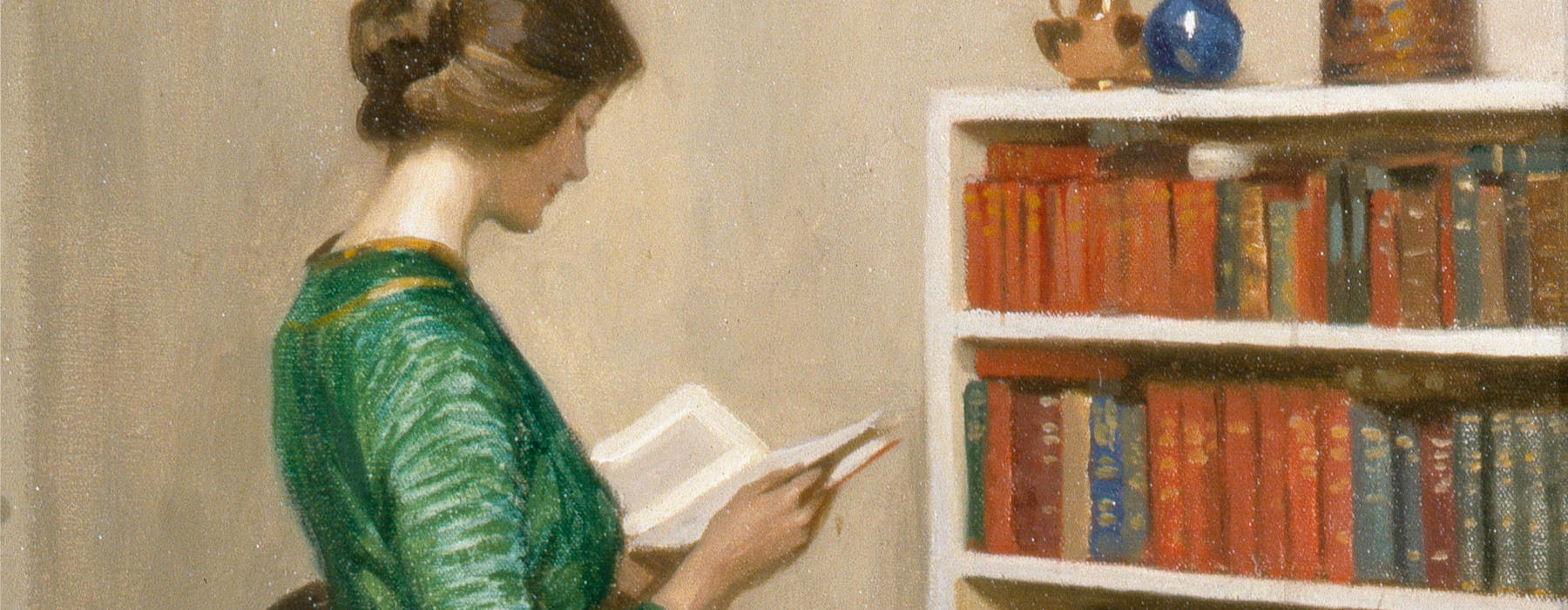 An oil painting of a woman reading a book in front of a bookcase.